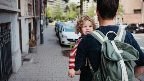 Dad with backpack walking in the city while holding his daughter – Rare Klub Backpacks That Actually Work: For Office, Travel, College, and More
